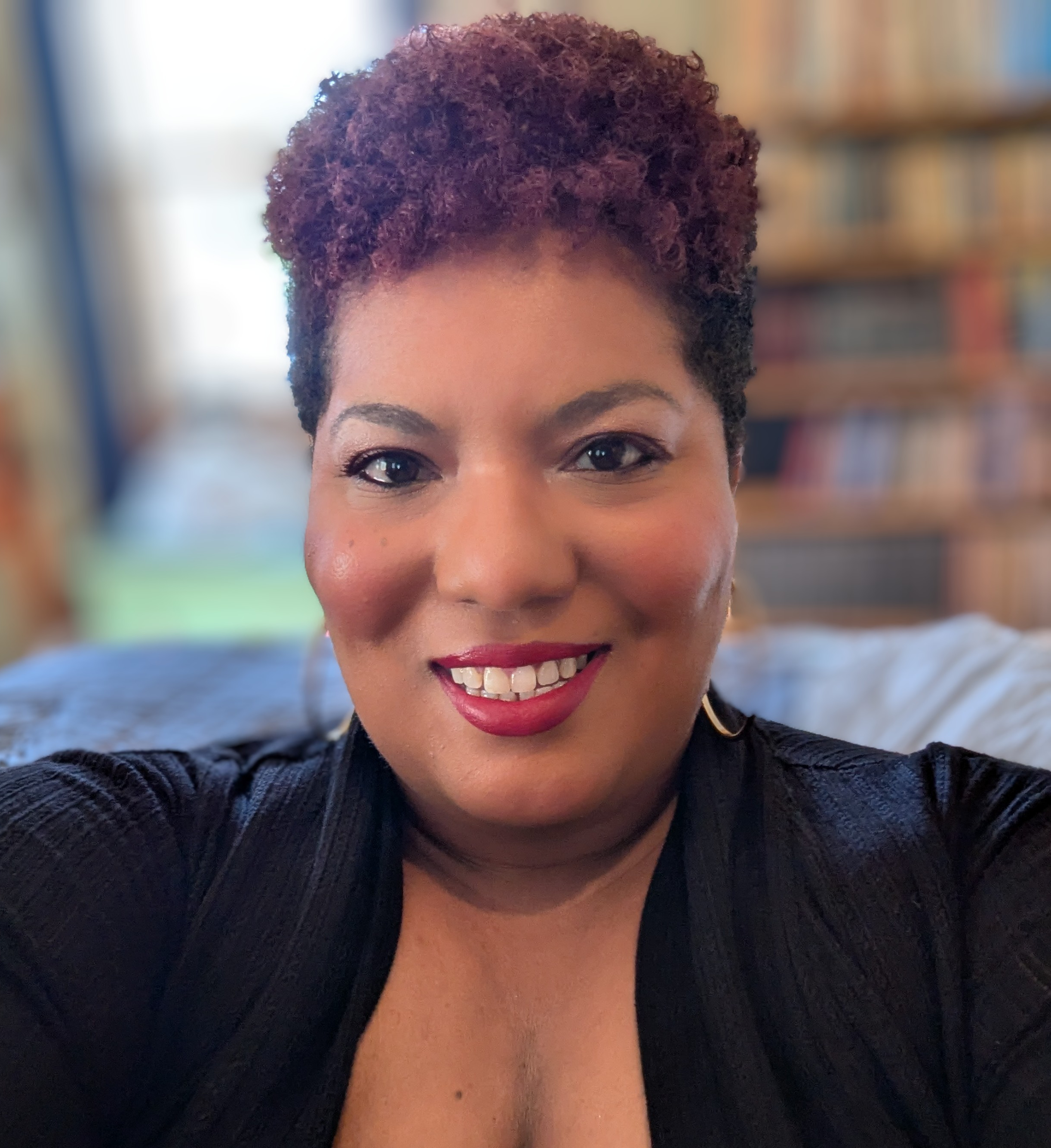 picture of Nicole (Black woman red and black hair) smiling 